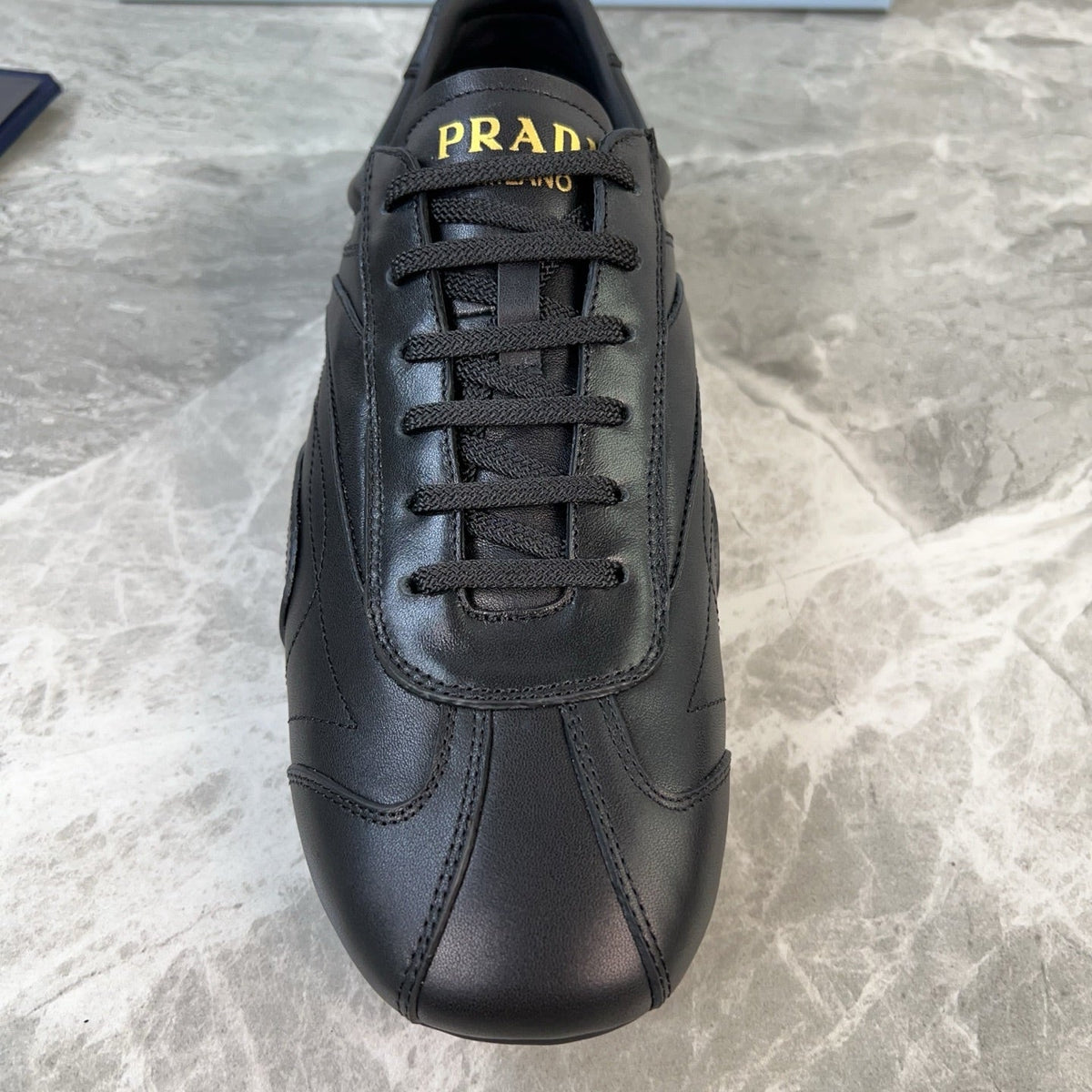 PRADA 25S MONTECARLO ANTIQUED SNEAKERS IN BLACK NAPPA LEATHER